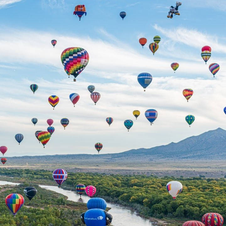 Colorful hot air ballons in a beautiful landscape.