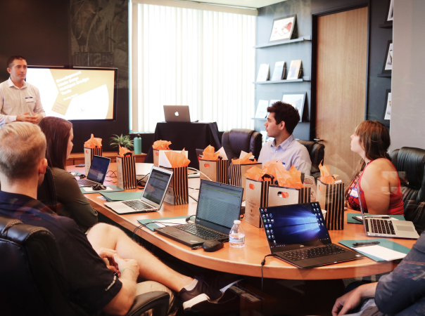 People in a conference room with laptops.