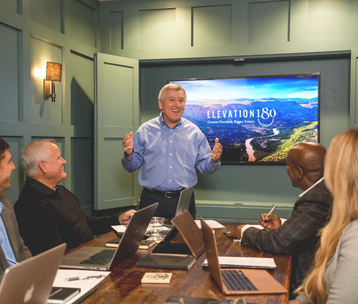 Jerry presenting at the front of a room.