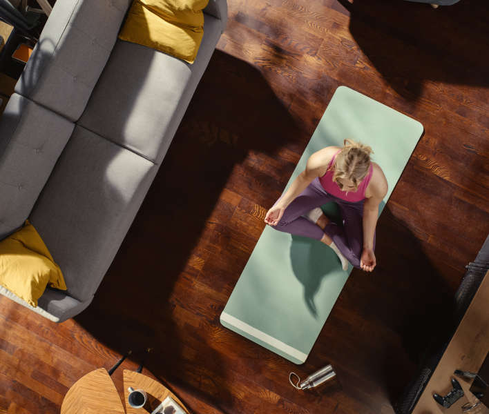 Women sitting on yoga mat.